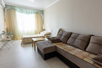 Image showing The interior of the bedroom in the apartment with a large sofa