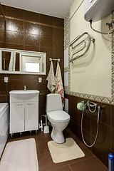 Image showing Fragment of the interior of the bathroom, wall view toilet and washbasin