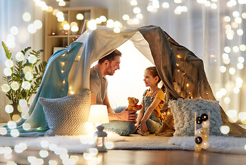 Image showing happy family playing with toy in kids tent at home