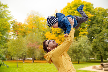 Image showing father with son playing and having fun in autumn