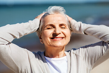 Image showing portrait of senior woman enjoying sun on beach