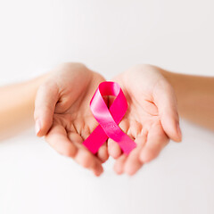 Image showing female hands holding pink cancer awareness ribbon