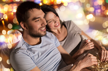 Image showing couple with popcorn watching tv at night at home