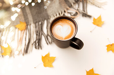 Image showing coffee with latte art, autumn leaves and blanket