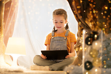 Image showing little girl with tablet pc in kids tent at home