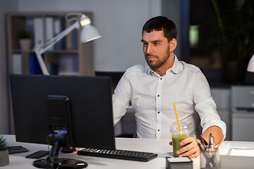 Image showing businessman with computer working at night office