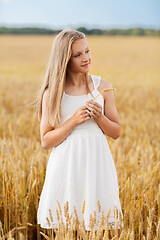 Image showing girl with spikelet of wheat on cereal field