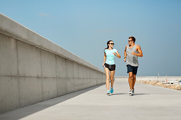 Image showing couple in sports clothes running outdoors