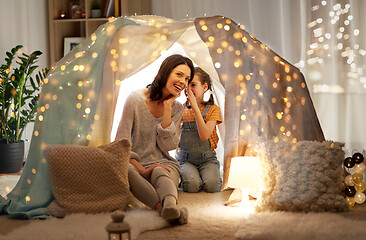 Image showing happy family whispering in kids tent at home