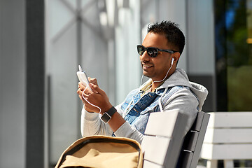 Image showing man with earphones and smartphone on city street