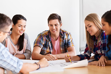 Image showing group of smiling students with blueprint