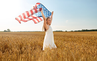 Image showing girl with american flag waving over cereal field