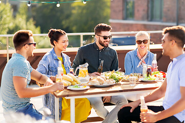 Image showing friends having dinner or bbq party on rooftop