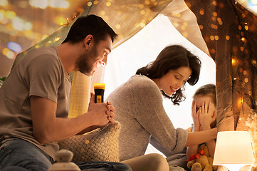 Image showing father telling scary stories to his daughter