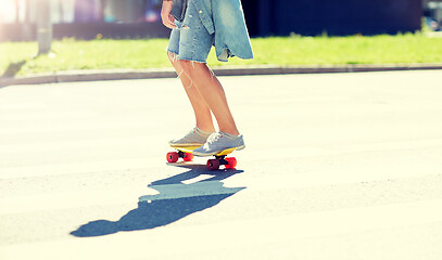 Image showing teenage boy on skateboard crossing city crosswalk