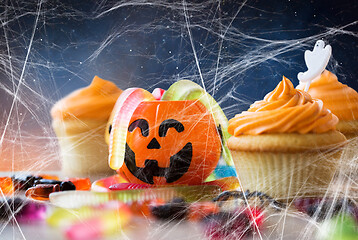 Image showing halloween party cupcakes and candies on table