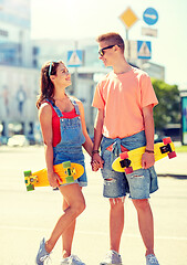 Image showing teenage couple with skateboards on city street