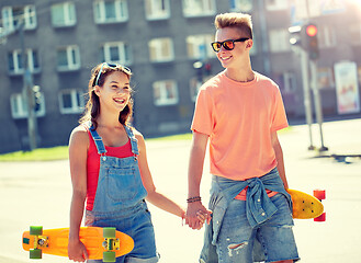 Image showing teenage couple with skateboards on city street