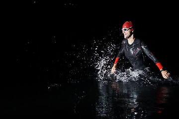 Image showing triathlon athlete finishing swimming training at dark night