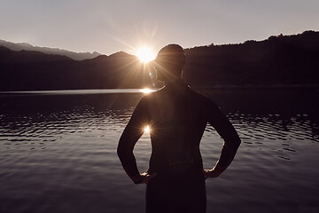 Image showing triathlon athlete starting swimming training on lake