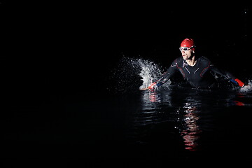 Image showing triathlon athlete finishing swimming training at dark night