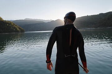 Image showing triathlon athlete starting swimming training on lake