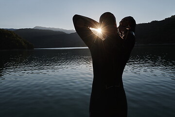 Image showing triathlon athlete starting swimming training on lake