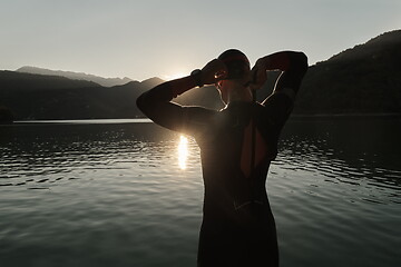 Image showing triathlon athlete starting swimming training on lake