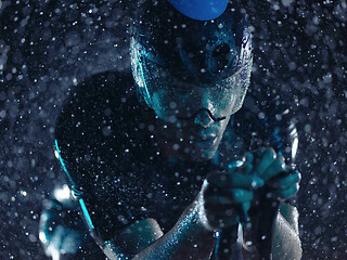 Image showing triathlon athlete riding bike on rainy night