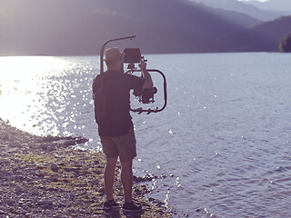 Image showing videographer taking action shot of triathlon swimming athlete