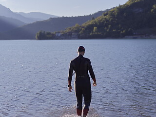 Image showing triathlete swimmer portrait wearing wetsuit on training