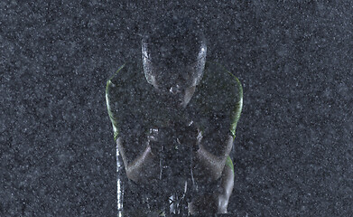 Image showing triathlon athlete riding bike on rainy night