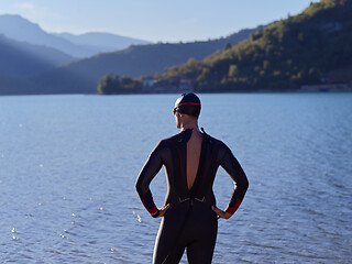 Image showing triathlete swimmer portrait wearing wetsuit on training