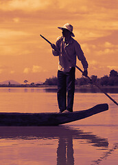 Image showing Dak Lak, VIETNAM - JANUARY 6, 2015 - Man pushing a boat with a pole