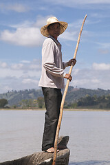 Image showing Dak Lak, VIETNAM - JANUARY 6, 2015 - Man pushing a boat with a pole