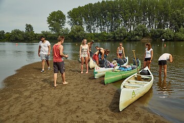 Image showing Canoes on the Riverside, People preparing for a trip