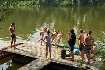 Image showing People jumping in the river from a pier