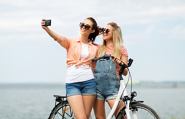 Image showing teenage girls with bicycle taking selfie in summer