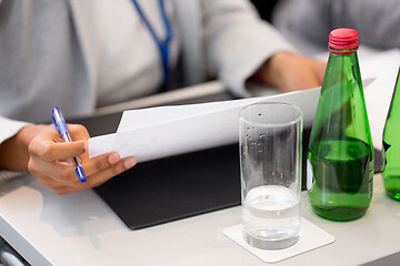 Image showing close up of businesswoman with files at conference