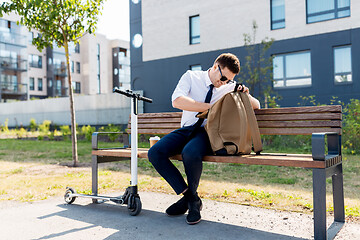 Image showing businessman with bag, scooter and coffee in city