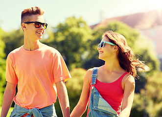 Image showing happy teenage couple walking at summer park