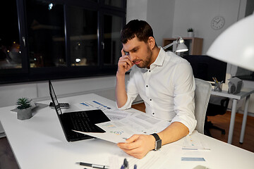 Image showing businessman with papers working at night office