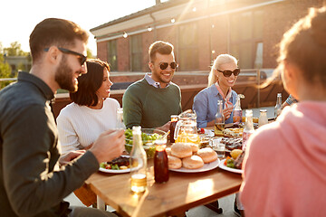 Image showing friends having dinner or bbq party on rooftop