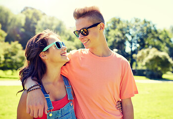 Image showing happy teenage couple looking at each other in park