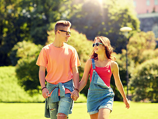 Image showing happy teenage couple walking at summer park