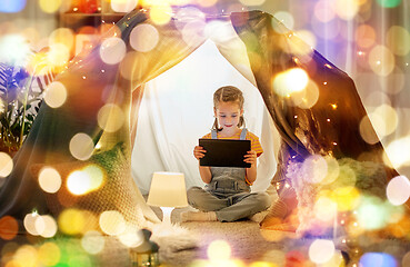 Image showing little girl with tablet pc in kids tent at home