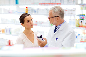 Image showing apothecary and woman with drug at pharmacy