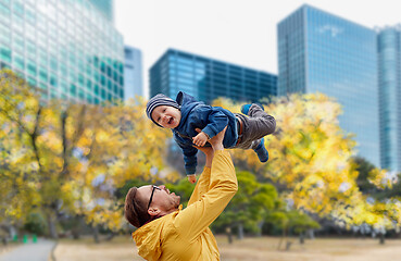 Image showing father with son having fun in autumn tokyo city