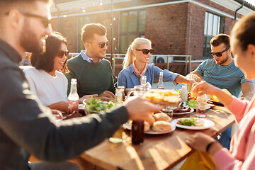 Image showing friends having dinner or bbq party on rooftop