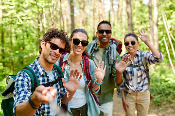 Image showing friends with backpacks hiking and taking selfie